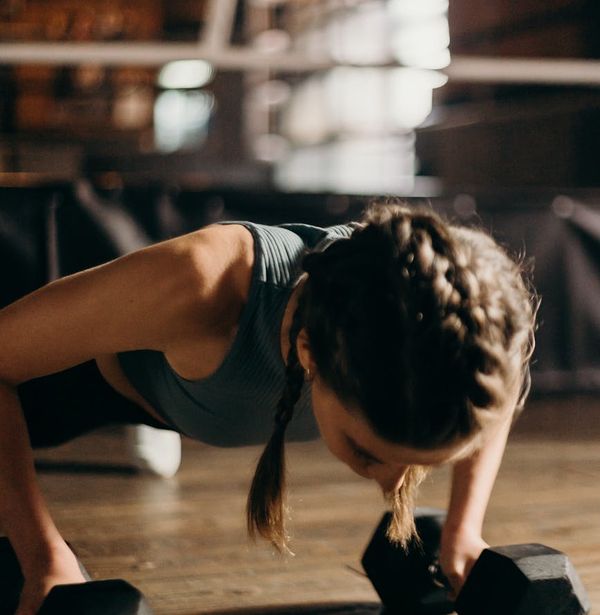 Man holding a plank position with perfect form in a modern gym.